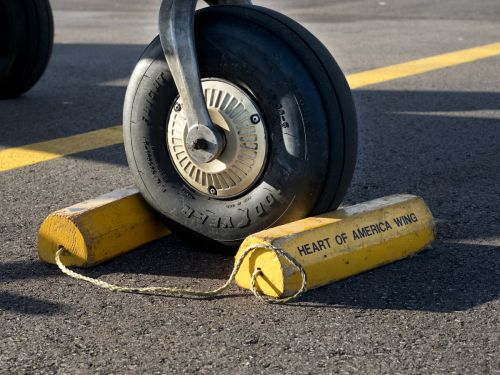 a chocked nose wheel of a parked small plane